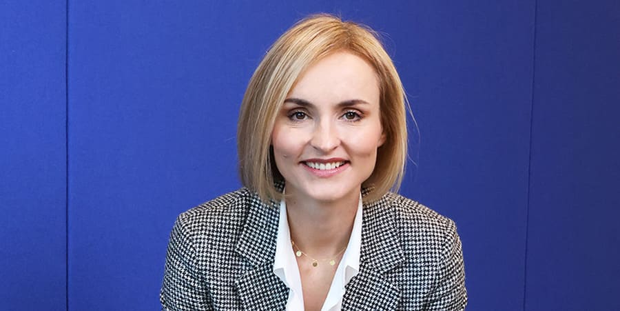 A smiling woman sitting in the studio