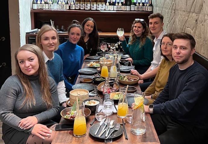 A group of people sitting in a restaurant having a business lunch